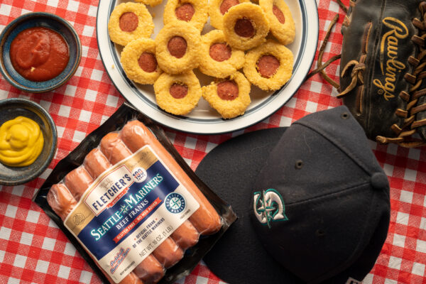 Seatle Mariners branded hot dog package with hand size corn muffins with hot dogs in the middle