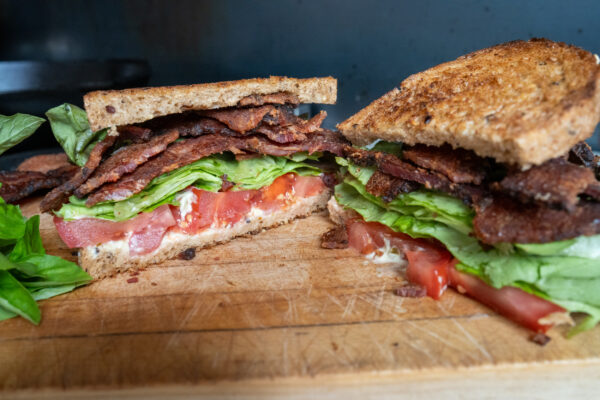 BLT sandwich featuring bacon, lettuce, tomato and pesto mayonnaise.